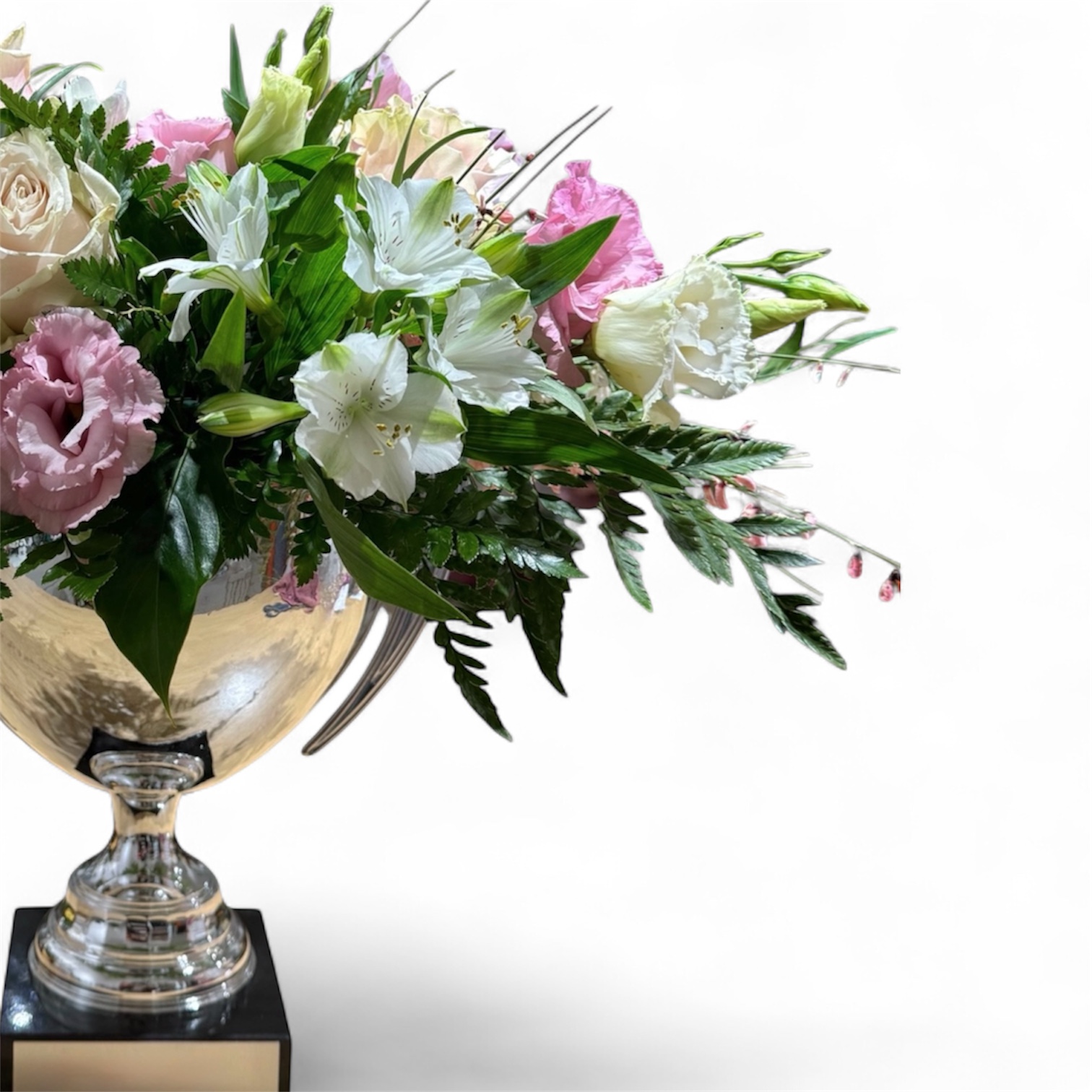 Composizione di rose e lisianthus in una coppa argentata